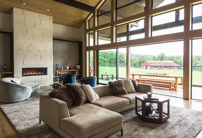 Modern luxury home interior floor to ceiling windows fireplace open living area