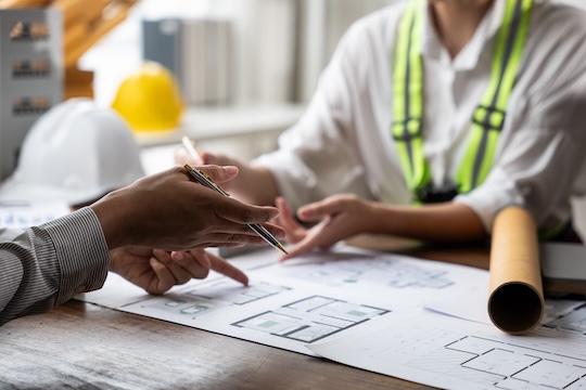 ADU builder reviewing floor plans custom design consultation
